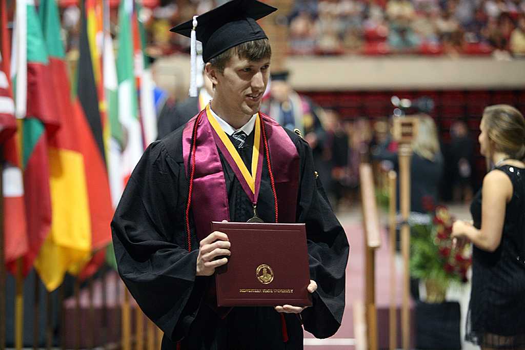 Cody Parrish, English graduate, waits to take his photo after crossing the stage at Midwestern State University graduation, May 10, 2014. Photo by Ethan Metcalf