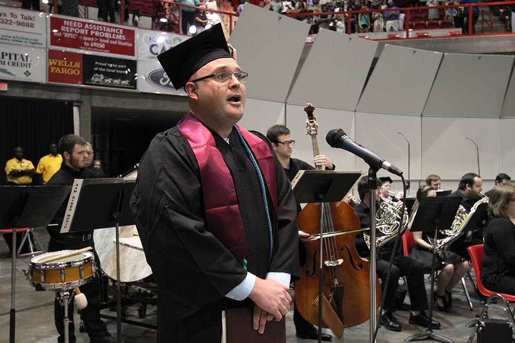 Jason Mincy, a senior in vocal music eduation, sings the alma mater at Midwestern State University graduation, May 10, 2014. Photo by Lauren Roberts