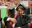 Kyle Eagan, mass communication graduate, hugs assistant professor Bradley Wilson at Midwestern State University graduation, May 10, 2014. Photo by Ethan Metcalf