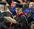 Elizabeth Minden and Sandra Grant, mass communication instructors, read the graduation programs at Midwestern State University graduation, May 10, 2014. Photo by Ethan Metcalf