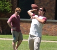 Sam Metzler, buisness freshmen, and Jordan Entler, buisness management freshmen throwing a football across the lawn at Alpha Phi and Kappa Alpha's First Annual Midwestern Cookout Classic in the Quadrangle on April 30. Photos by Kayla White.
