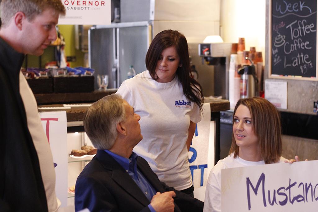 Jonothan Lyne, junior in economics, Annie Kleinschmidt, senior in radiology and an unknown MSU student spoke to gubernatorial hopeful Greg Abbott after his rally at the 8th Street Coffee House in Wichita Falls, Feb. 18. Photo by Sam Croft.