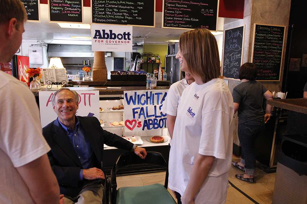 Jonothan Lyne, junior in economics, Annie Kleinschmidt, senior in radiology and an unknown MSU student spoke to gubernatorial hopeful Greg Abbott after his rally at the 8th Street Coffee House in Wichita Falls, Feb. 18. Photo by Sam Croft.