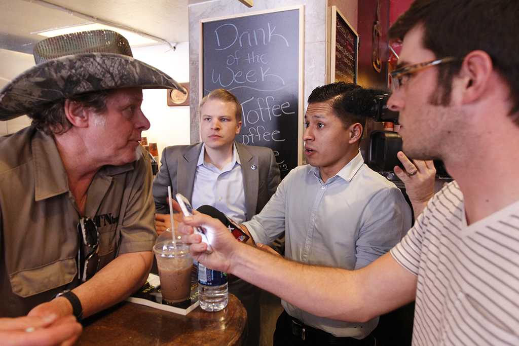 Wichita reporters Eddie Miller talks with singer Ted Nugent. Nugent traveled with tubernatorial hopeful Greg Abbott to 8th Street Coffee House in Wichita Falls, Feb. 18. Photo by Sam Croft.