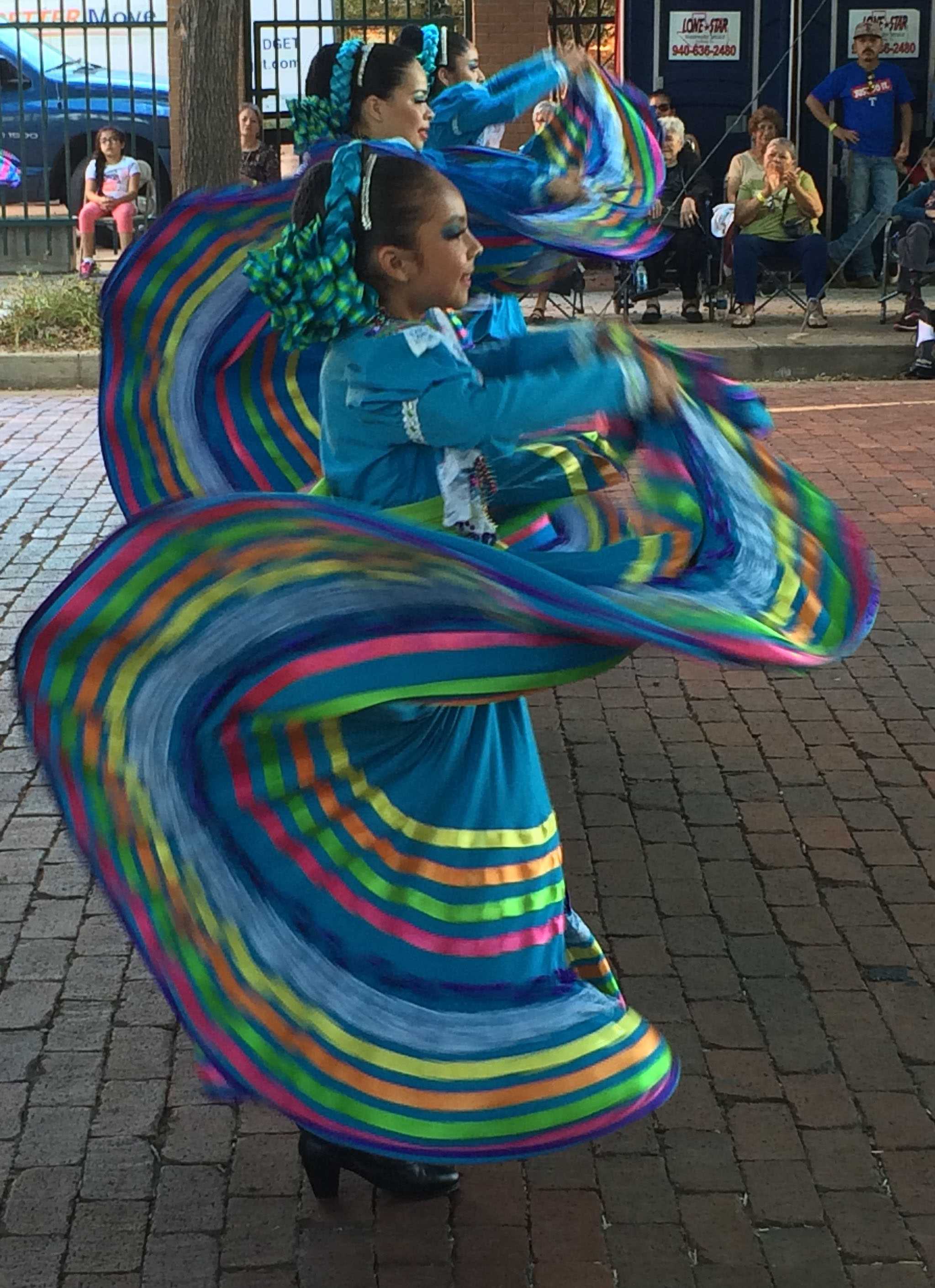 Members of Grupo Folklorico Faisan, a travelling group from California, perform at Calle Ocho on Oct. 1 at the downtown Farmer's Market. Photo by Emily Simmons