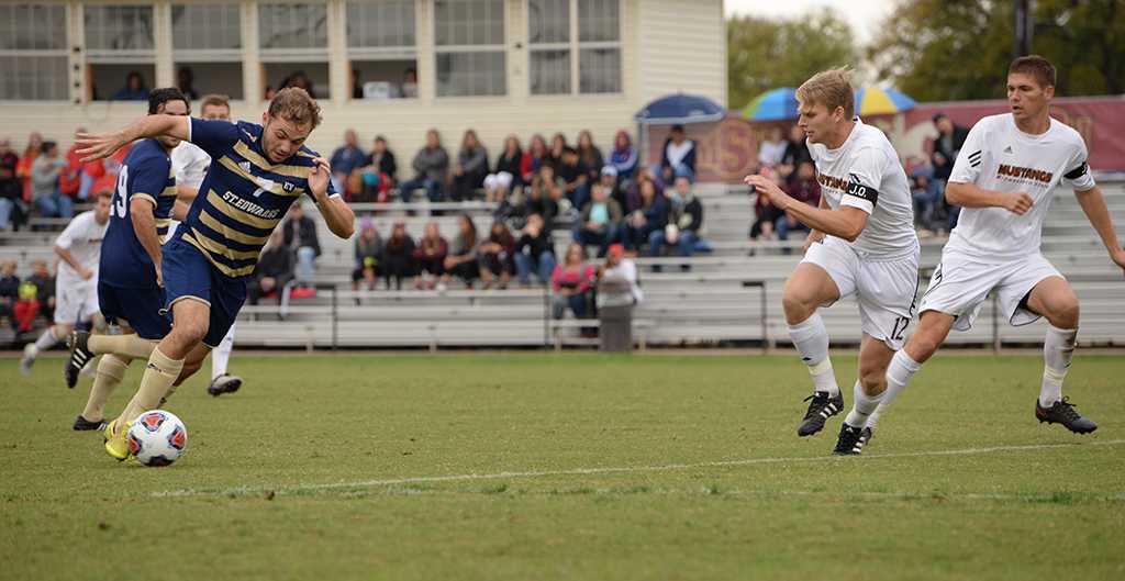 Alex Mullet and Patrick Fitzgerald run for the ball at the Heartland Conference playoff game against St. Edward's. MSU lost 0-2. Photo by Zack Santagate
