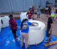 Jennifer Arbuckle, mechanical engineering senior, LatourJasmine Richardson, physical therapy junior, and other member of the women's basketball team, along with area residents, spent Friday afternoon cleaning tubs to be used for water in the Hotter ’N Hell. Photo by Izziel) Photo by Izziel Latour