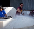 Jennifer Arbuckle, mechanical engineering senior, and other member of the women's basketball team, along with area residents, spent Friday afternoon cleaning tubs to be used for water in the Hotter ’N Hell. Photo by Izziel Latour