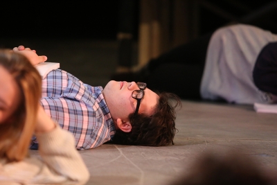Home-school senior Steven Kintner, who plays Tiny Tom, pretends to sleep on the set of Urinetown the Musical on Wednesday, Jan. 19, 2018. Photo by Mekala Conway