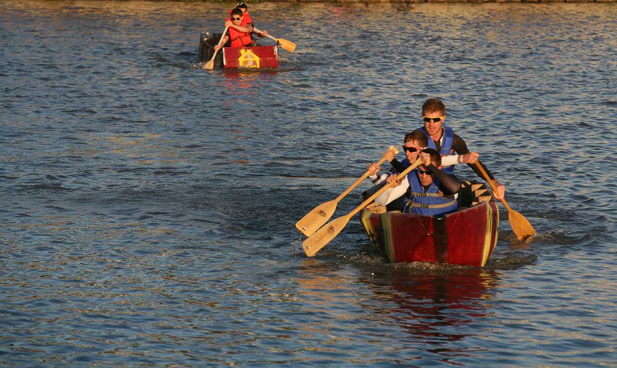 The cycling team, Anthony Sequera, Cameron Lowery and Sam Croft, returns to shore during the cardboard boat race in Sikes Lake Oct. 24, 2014. Photo by Bradley Wilson