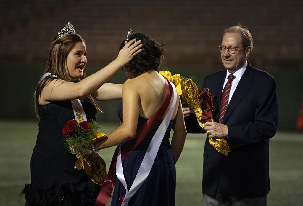 Sabina Marroquin gets her crown as the 2014 homecoming queen from the 2013 recipient Kayla Gray. Photo by Bradley Wilsonat the homecoming game, Oct. 25, 2015. Photo by Bradley Wilson
