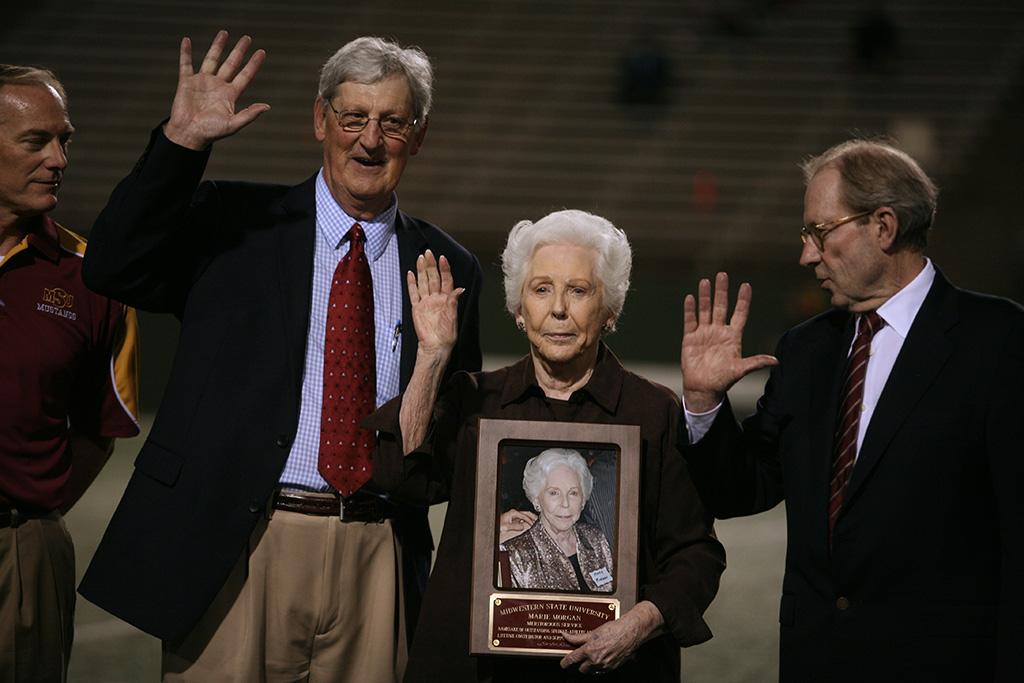 Athletic Director Charlie Carr and University President Jesse Rogers recognized Marie Morgan for Meritorius Service as the namesake of the outstanding student athlete and a lifetime contributor of the MWSU athletic program at the homecoming game, Oct. 25, 2015. Photo by Bradley Wilson