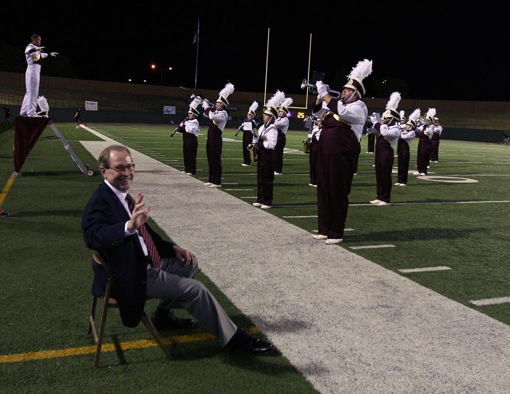 Retiring university President Jesse Rogers listens as the band plays a series of songs in recongition of his retirement at the homecoming game, Oct. 25, 2015. Photo by Bradley Wilson