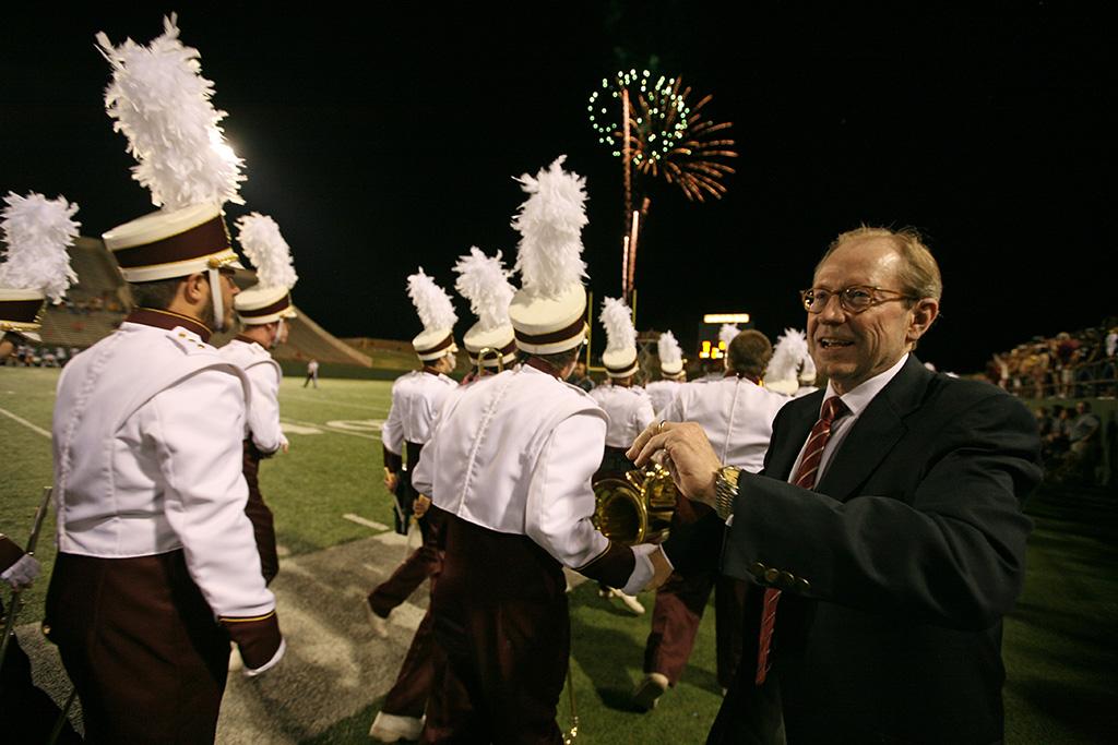 University President Jesse Rogers thanks band members after halftime during which the band played a series of songs recognizing Rogers who is retiring at the end of the year at the homecoming game, Oct. 25, 2015. Photo by Bradley Wilson