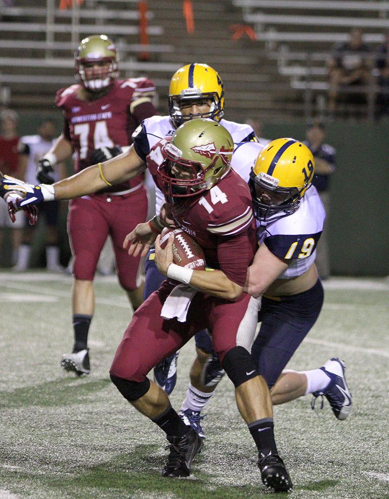 Quade Coward, exercise physiology sophomore, is sacked in the game between Midwestern State University and Texas A&M-Commerce, Saturday, Oct. 25, 2014 at Memorial Stadium. Photo by Lauren Roberts