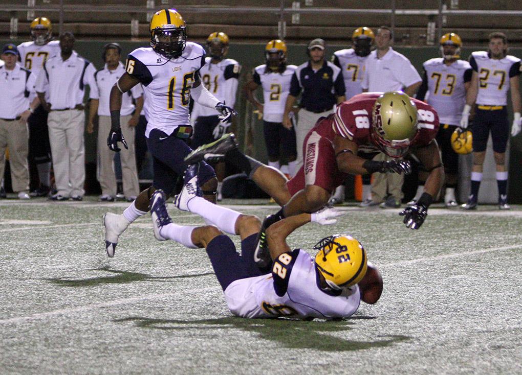 Ricardo Riascos, criminal justice senior, hits Commerce's freshman wide-reciever Shawn Hooks as he tries to catch a punt in the game between Midwestern State University and Texas A&M-Commerce, Saturday, Oct. 25, 2014 at Memorial Stadium. Photo by Lauren Roberts