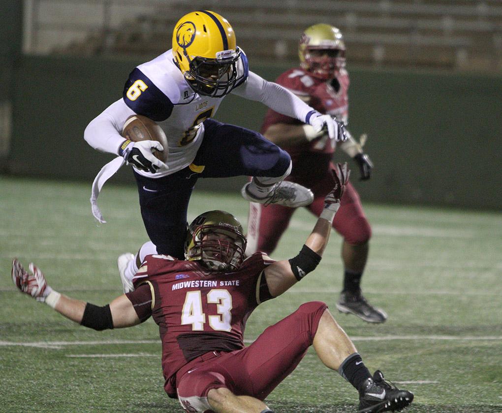 Adam Hill, history sophomre, tackles Commerce's Vernon Johnson, senior wide reciever, in the game between Midwestern State University and Texas A&M-Commerce, Saturday, Oct. 25, 2014 at Memorial Stadium. Photo by Lauren Roberts