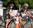Felicia Westermark-Svanehed and Hannah Ross waits to cross the road at the Hotter 'N Hell men's crit races Friday afternoon.