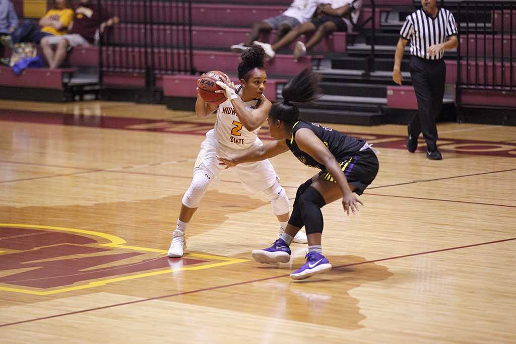 Jasmine Richardson, exercise physiology senior, moves the ball away from opponets reach during the MSU vs Hardin-Simmons game in D.L. Ligon Coliseum where MSU won 61-42, Thursday, Nov. 2, 2017. Photo by Francisco Martinez