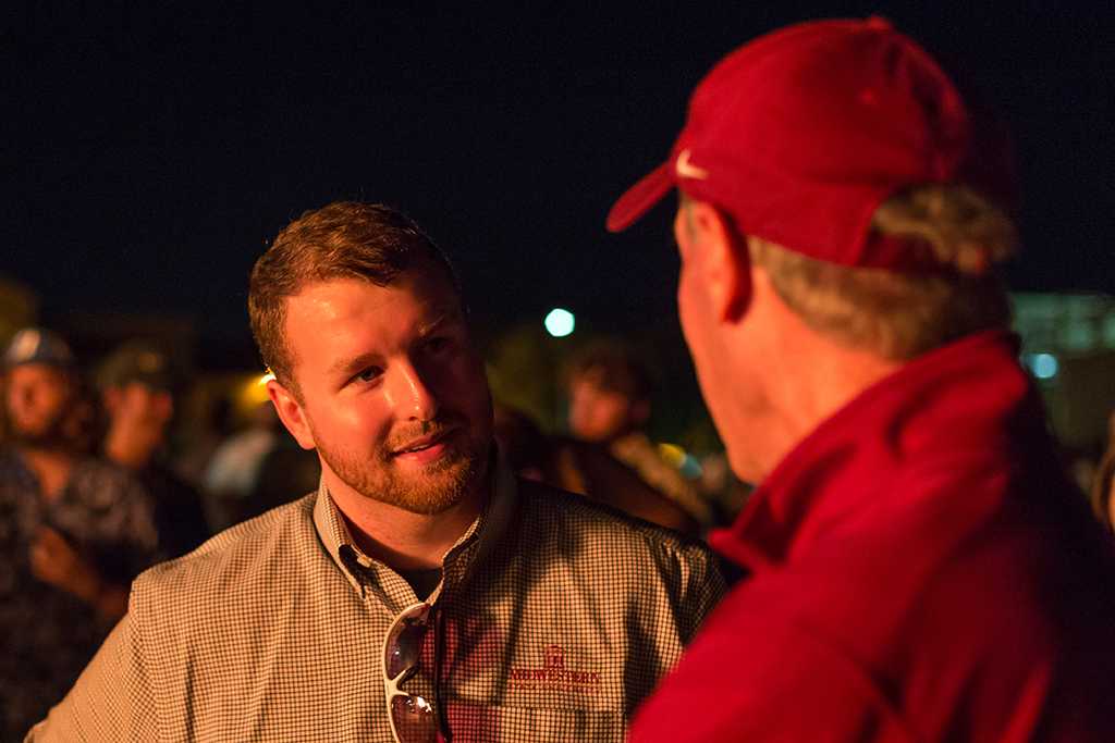 Jessie Brown, graduate student, talking to head football coach Bill Maskill at the homecoming bonfire on Oct. 27, 2016. Photo by Izziel Latour