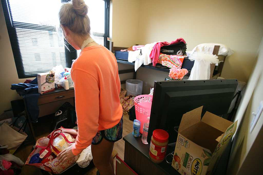 Ellie Gunderson, a sophomore in political science, in her new room during Move-in for Legacy Hall at Midwestern State University, Aug. 20, 2016. Photo by Bradley Wilson