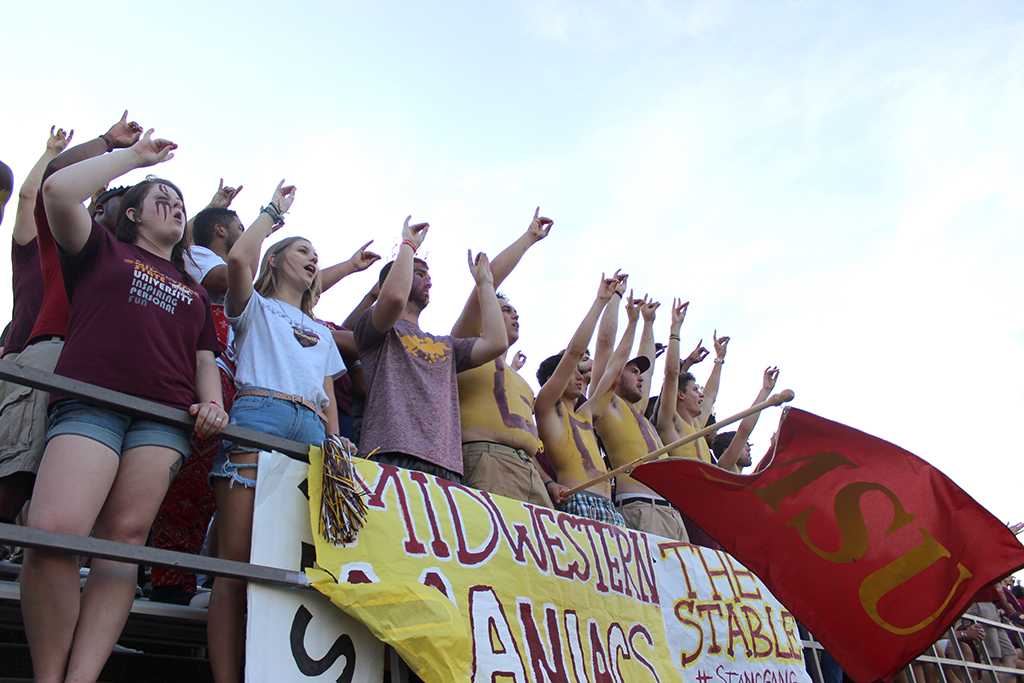 The Mustang Maniacs hold up the 'stang' sign while yelling as Midwestern State's kicker, Andy Alkhazshvilly, business management senior, starts off the first game of the season, Sat. Sept. 5. MSU beat Truman State 31-3 at Memorial Stadium. Photo by Rachel Johnson