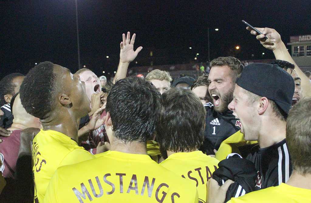 The men's soccer team gathers around cheering, jumping around, and filming their victory on snapchat after another win and continuation of their undefeated streak for this year's season. MSU beat St. Edward's University 3-2. Photo by Rachel Johnson