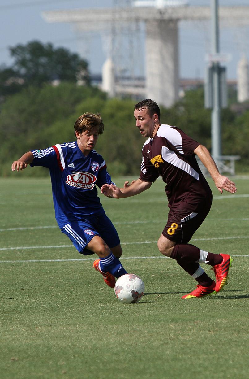Andrew Power, business senior, runs past a FC Dallas defender at Moneygram Soccer Park in Dallas Saturday afternoon. The match ended 2-0. Photo by Lauren Roberts