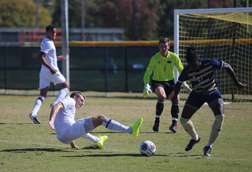 Alex Mullett goes down while trying to take a ball during the Heartland Conference championship game aginst St. Edwardâs University. MSU won 1-0. Photo by Bradley Wilson