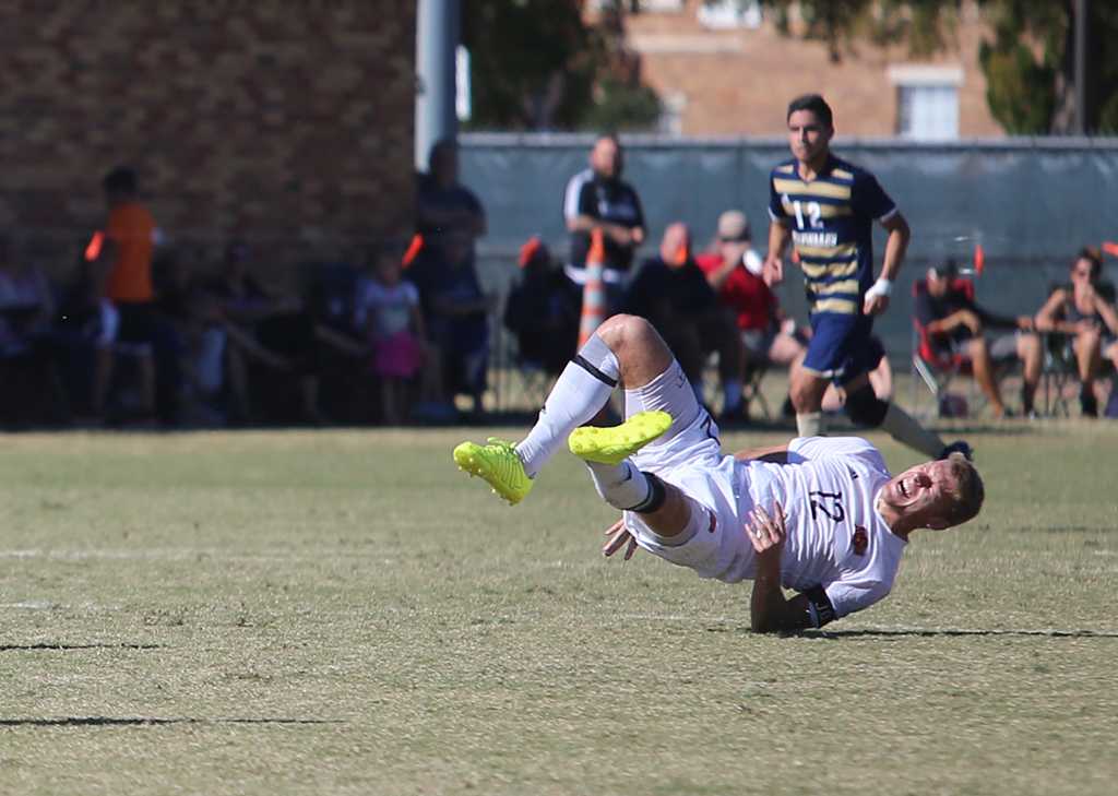 Defender Alex Mullet goes down hard in the Heartland Conference championship game aginst St. Edwardâs University. MSU won 1-0. Mullet was not injured. Photo by Bradley Wilson