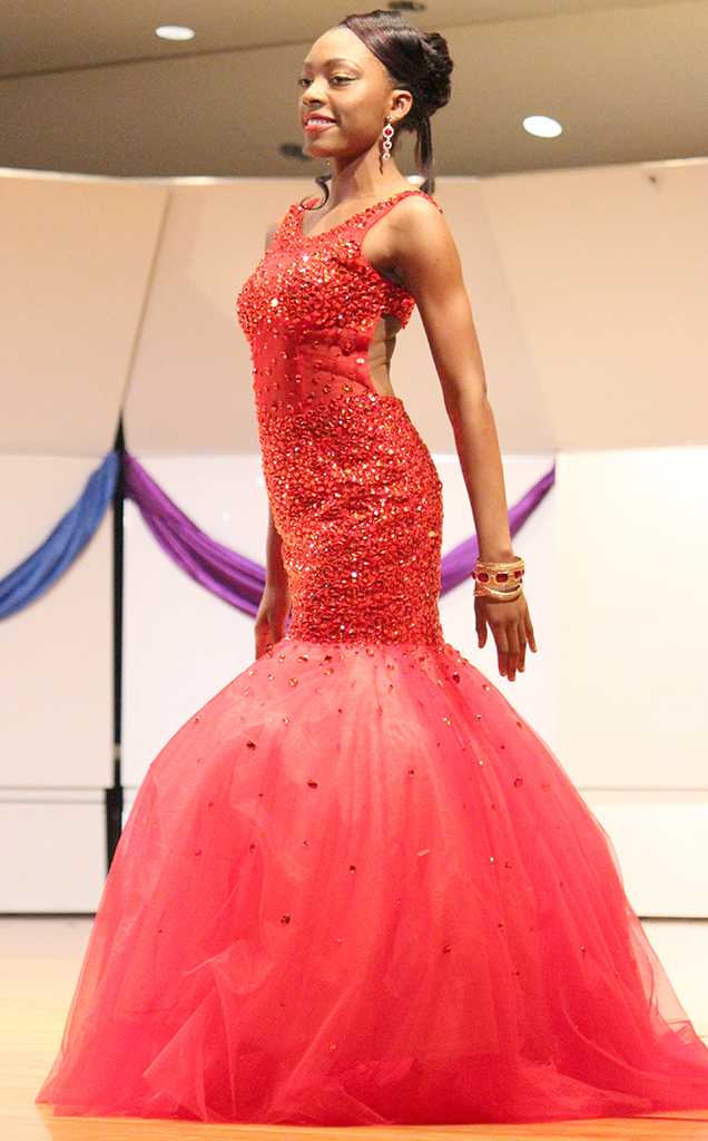 Jorrey Martin, special education sophmore and Miss CaribFest 2015, walks around the stage in Akin Auditorium, modeling her gown for the evening wear portion of the 2015 CaribFest Pageant, Sept. 23. Photo by Rachel Johnson