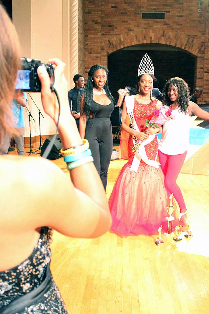 Jorrey Martin, special education sophmore and Miss CaribFest 2015, gets her picture taken with Careisha Whyte, accounting senior, and Daria Roach, accounting senior, after being announced queen at 2015 CaribFest Pageant, Sept. 23. Photo by Rachel Johnson