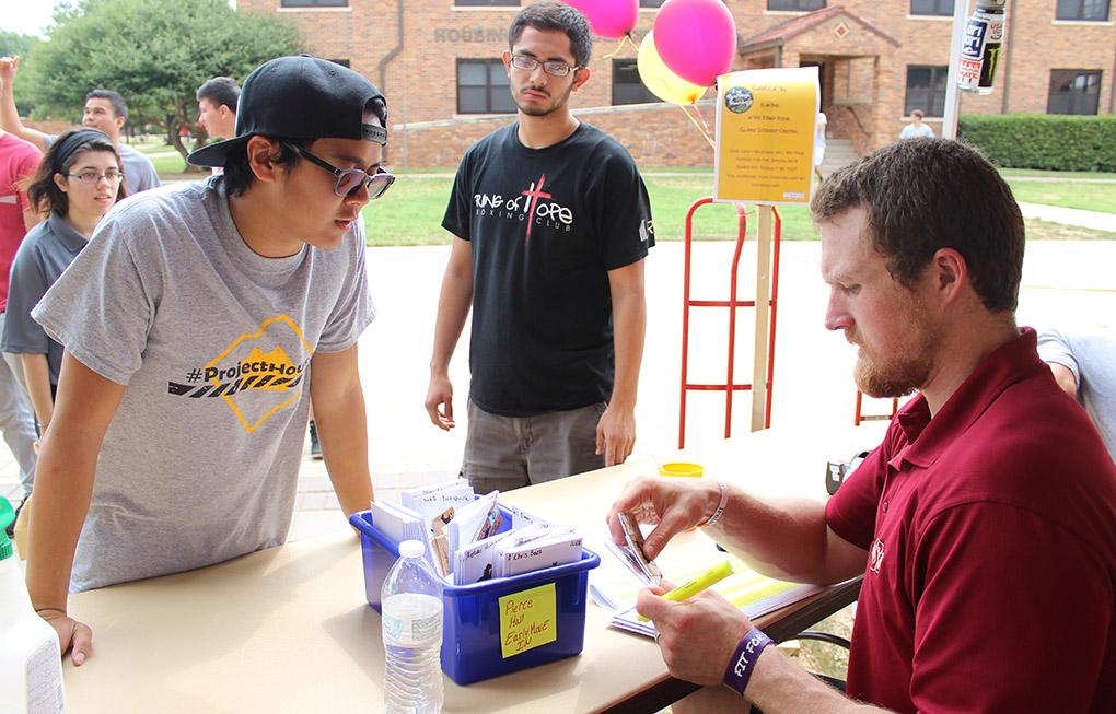 James Huynh, nursing junior, helps Clint Coulter, residence hall director, search through the Pierce resident's keys for a new student at Move In Day, Tuesday, August, 18, 2015. Photo by Rachel Johnson