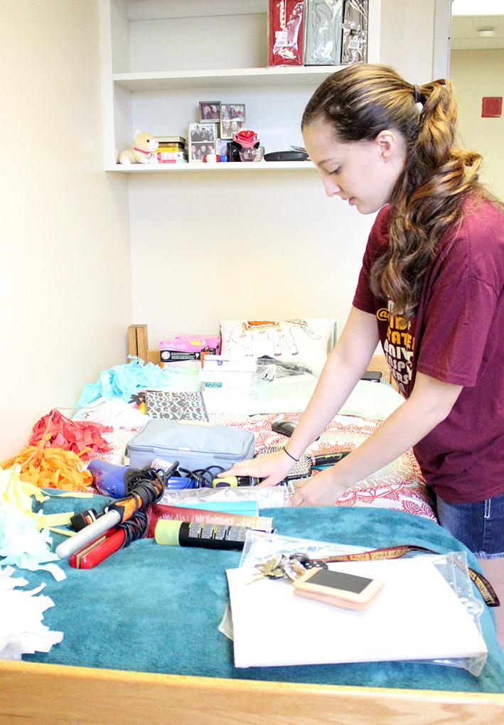 Alessandra Cerreta, bio pre-med freshman, reorganizes all the stuff left on her bed to put away in her new room in McCullogh Trigg on Move In Day, Tuesday, August, 18, 2015. "What I'm most excited for is getting to experience things that I never have before and hopefully having fun. I'm nervous for my classes, lectures, and my professors," Cerreta said. Photo by Rachel Johnson