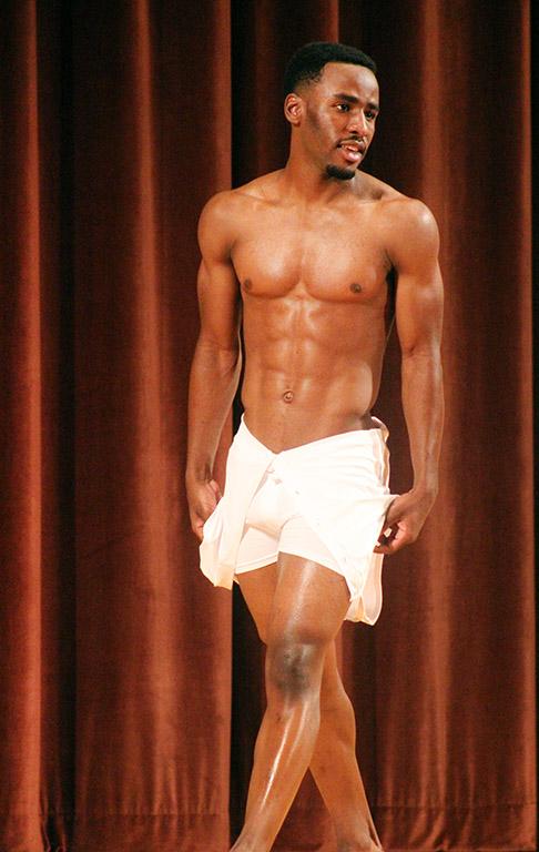 Rocksen Jean-Louis, music sophomore, shows off his bathing suit during the swim wear portion of the Mr. and Mrs. Caribfest in Akin Auditorium on Sept 28. Photo by Marissa Daley