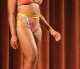 Valandra Jno Marie, freshman management, struts her orange patterened swimsuit for the bathing suit portion of the 2017 Mr. and Mrs. Caribfest in Akin Auditorium on Sept 28. Photo by Marissa Daley