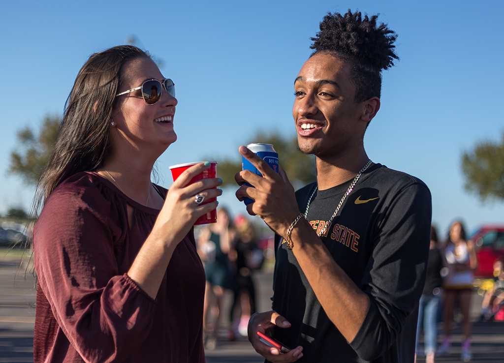 Caitlin Cooper, BAAS senior, & Zach Alvarez, education freshman enjoying the tailgate party before the start of the football game against Angelo State on Oct. 15. Photo by Izziel Latour