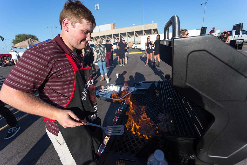 Brian Warren, finance senior, is grilling during the tailgate party before the start of the football game against Angelo State on Oct. 15. Photo by Izziel Latour