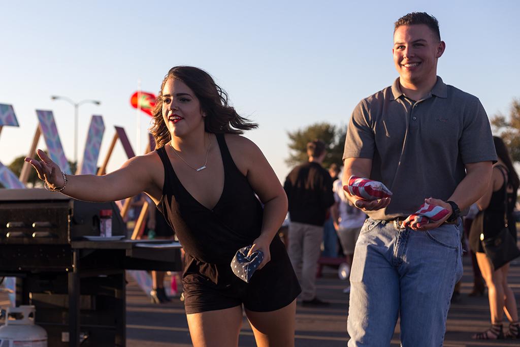 Sonata Brown, education freshman, & Thomas Herrera, criminal justice freshman, playing games during the tailgate party before the start of the football game against Angelo State on Oct. 15. Photo by Izziel Latour
