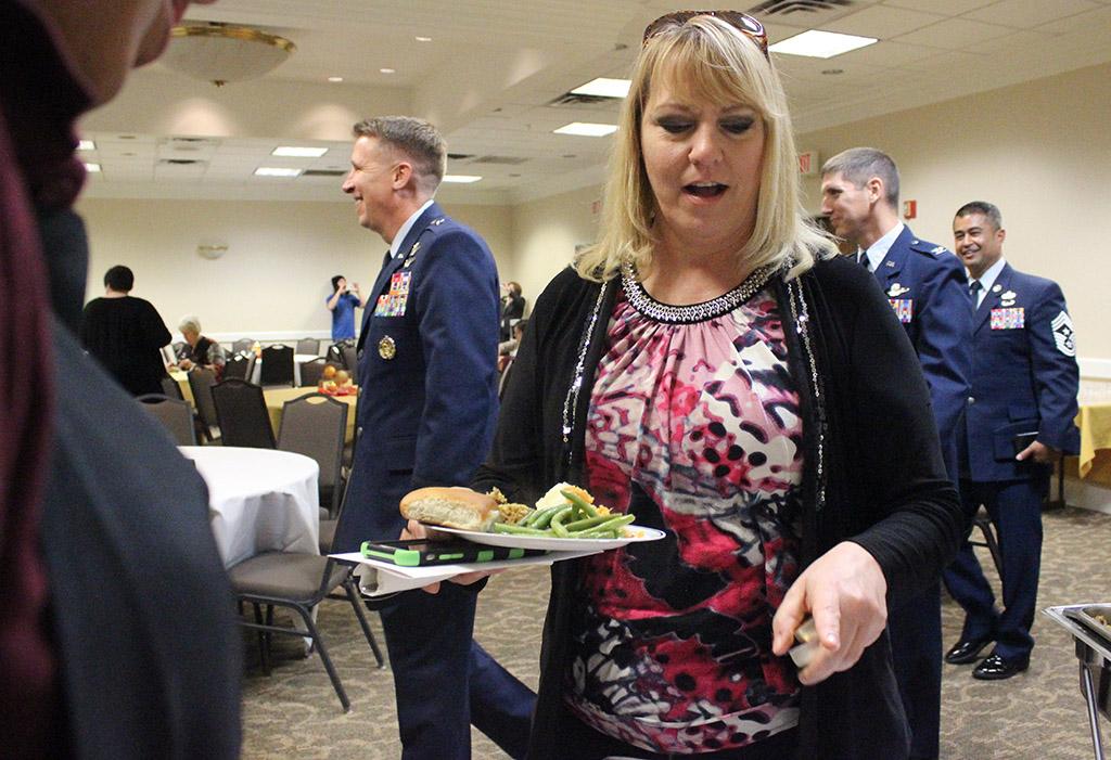 Mary Lassetter, administrative assistant for the office of residence life, gets food from the Holiday Luncheon held in CSC Comanche Suites after the Inaguration of Suzanne Shipley, the eleventh president, held in Fain Fine Arts Auditorium, Dec. 11. Photo by Rachel Johnson