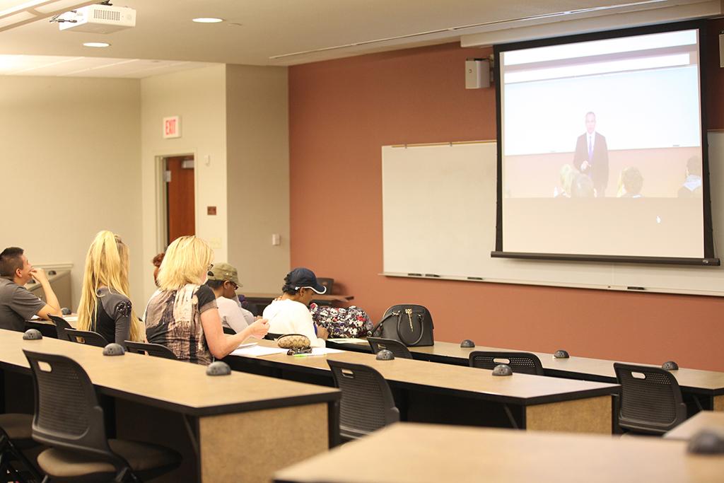 Students watch the live stream of Robert Bryce, guest speaker, talk on energy during the 34th Annual Streich Family Lecture Series on free enterprise in Dillard 121, which was used as an overflow and late comer room, Feb. 18. The actual event was held in Dillard 101, which filled up. Photo by Francisco Martinez