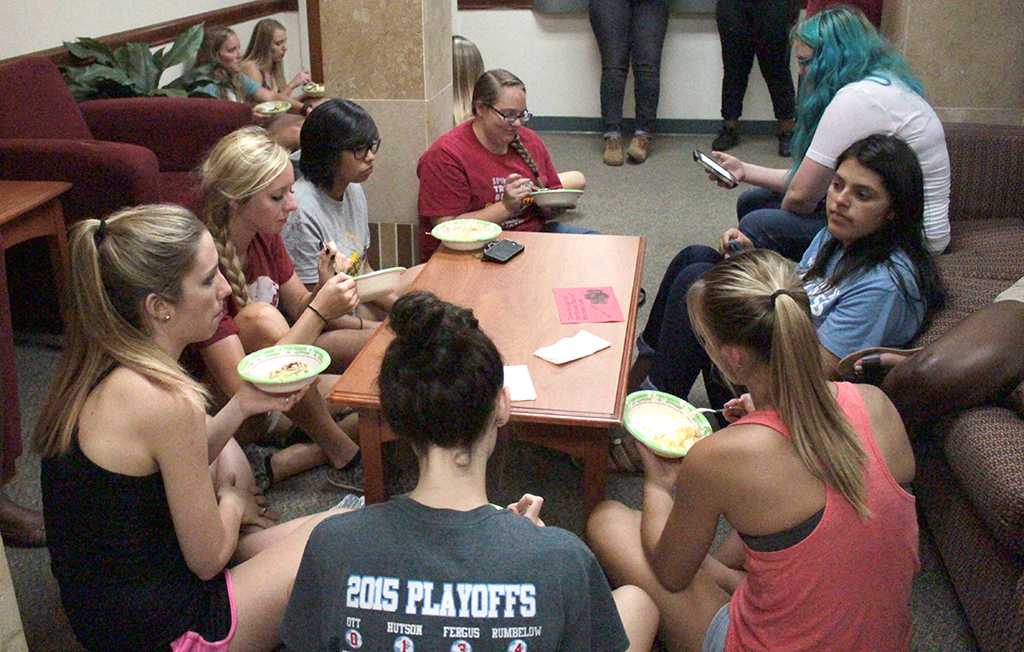 Students sit together, enjoying ice cream at the Ice cream social organized by the Residence Hall Association in the lobby of Killingsworth on Aug 24th. Photo by Kayla White.