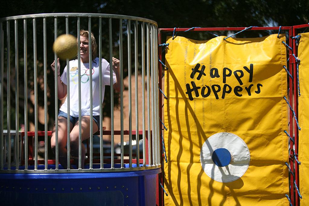 Morgan White, psychology sophomore, sits on the dunking booth during Roundup Olympics on the Quad Aug. 24. "The water wasn't cold," she said. "It feels uncomfortable being in the water in front of everybody." Photo by Bradley Wilson
