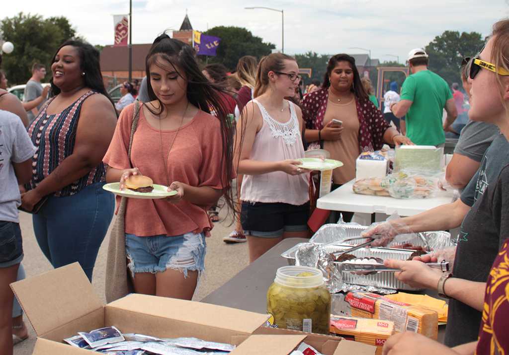 Students pass through line for free burgers and hot dogs at the Party at the soccer field on Aug 23rd in the parking lot of the soccer field. Photo by Kayla White.