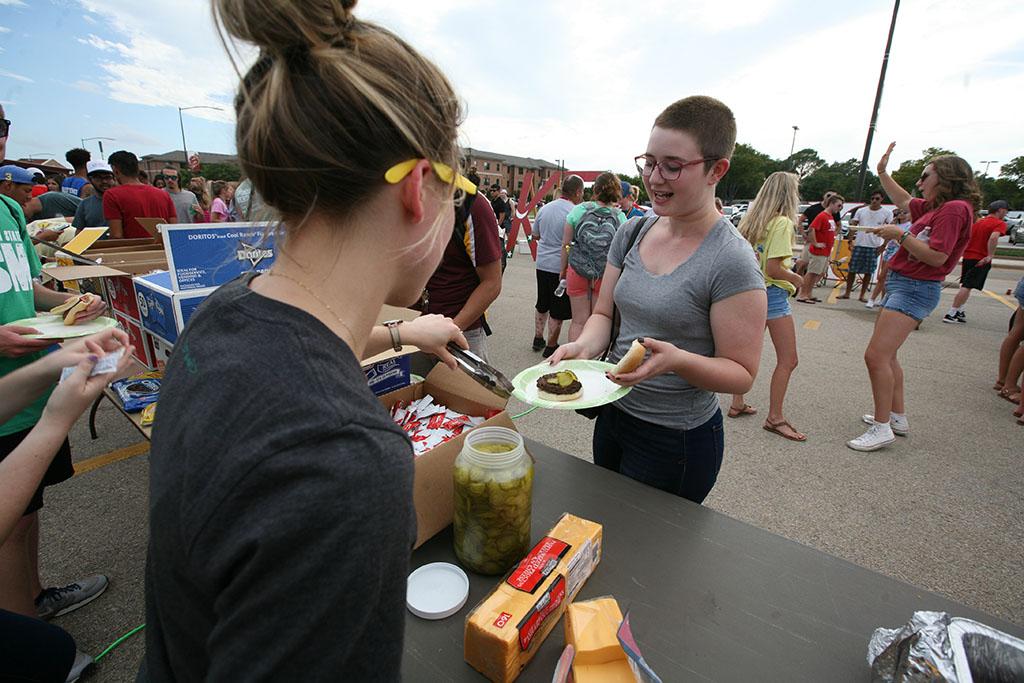 An MSU student gets a free hamburger from the Baptist Student Ministry. Photo by Bradley Wilson