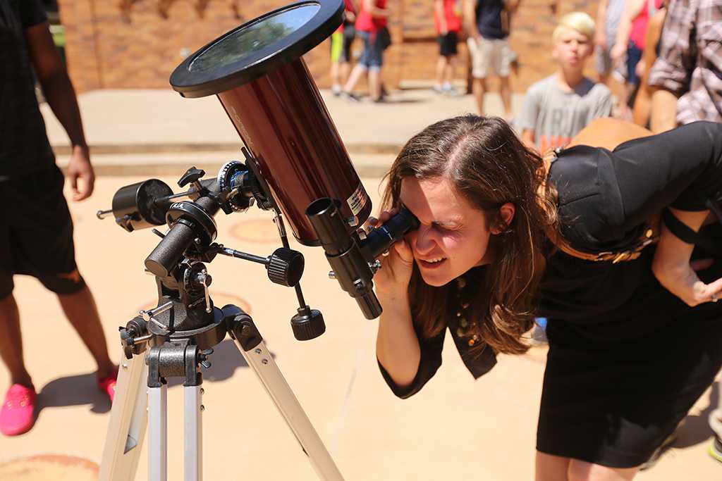At 12:25 p.m. Amy Chase looks at the solar eclipse watch party Aug. 21, 2017 on Sunwatcher Plaza at Midwestern State University. Photo by Bradley Wilson
