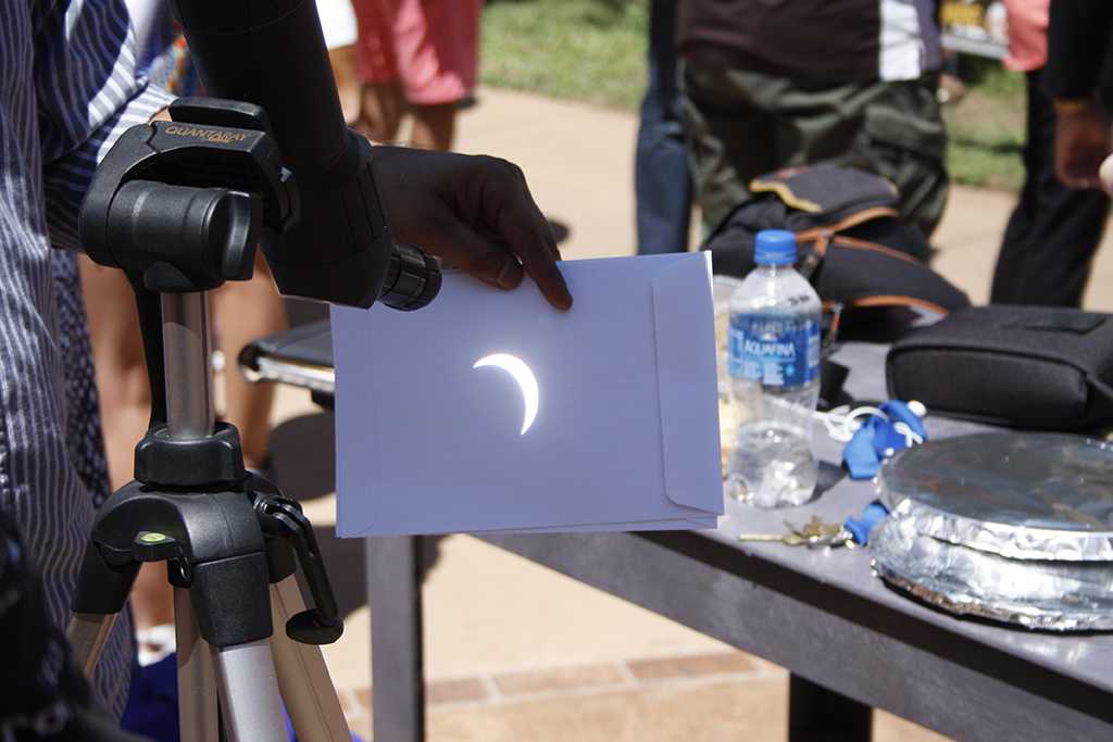 A phase of the solar eclipse projected through a telescope onto an envelope in the Sunwatcher Plaza on Aug. 21. Photo by Justin Marquart