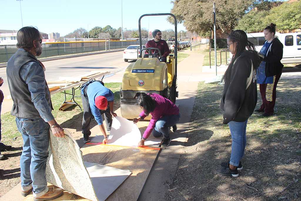 Faculty and students gather outside of Fain Fine Arts for the Steamroller Print Event on Nocona Trial set up as a collaboration between MSU's Harvey School of Visual Arts and Wichita Falls Independent School District high schools, Feb 9, 2016. Photo by Francisco Martinez