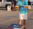 Caleb Pylant, biology junior, plays a game of bean bag toss set up by Sigma Alpha Epsilon in the new designated tailgating section of the parking lot outside of Memorial Stadium, Saturday Sept. 5, 2015. Midwestern State beat Truman State 31-3 in their opening game of the season. Photo by Rachel Johnson