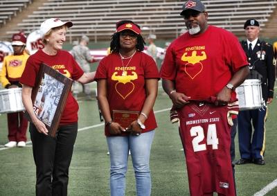 President Shipley, Tammy Grays, and Robert Grays, stand in honor of Robert Grays to retire the number 24 at the Memorial Stadium during the football game against Tarleton State on Nov. 4, 2017. Photo by Harlie David